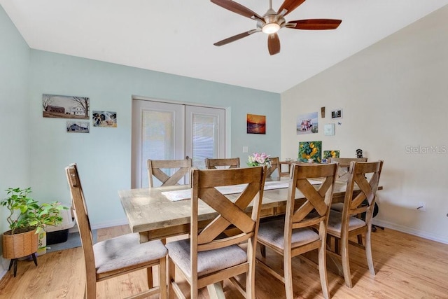 dining area with ceiling fan and light hardwood / wood-style floors