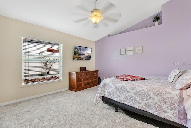 carpeted bedroom with ceiling fan and vaulted ceiling