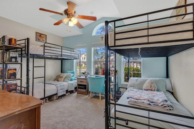 bedroom featuring ceiling fan, carpet flooring, and lofted ceiling