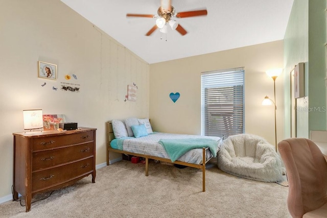 carpeted bedroom with ceiling fan and vaulted ceiling