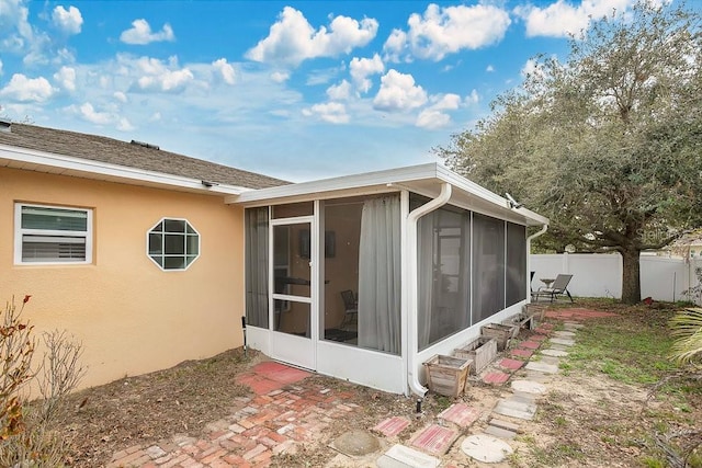 view of side of home featuring a sunroom