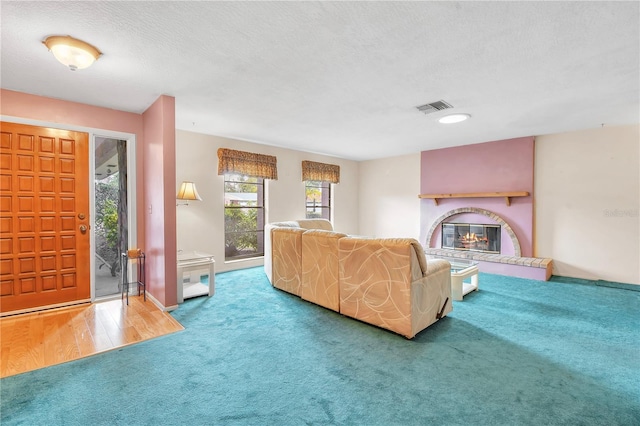 living room featuring carpet floors and a textured ceiling