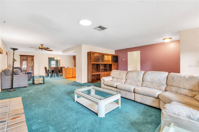 living room featuring carpet and ceiling fan