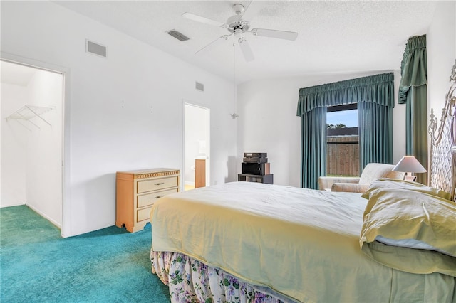 bedroom featuring a spacious closet, ceiling fan, carpet floors, lofted ceiling, and a closet