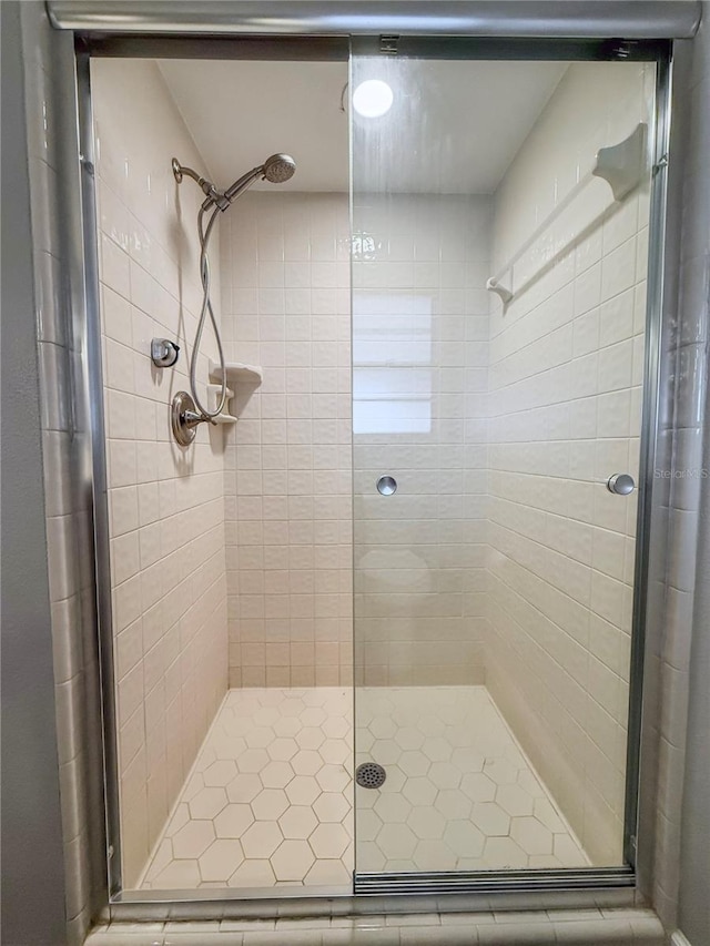 bathroom featuring a shower with door