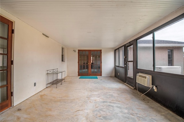 view of patio with a wall mounted AC and french doors