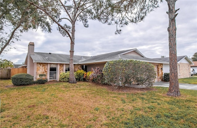 ranch-style house featuring concrete driveway, a chimney, an attached garage, fence, and a front lawn