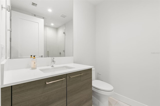 bathroom with tile patterned floors, walk in shower, vanity, and toilet