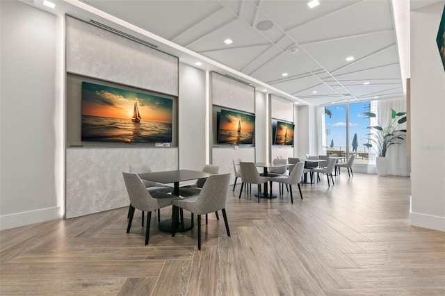 dining space with expansive windows and parquet flooring