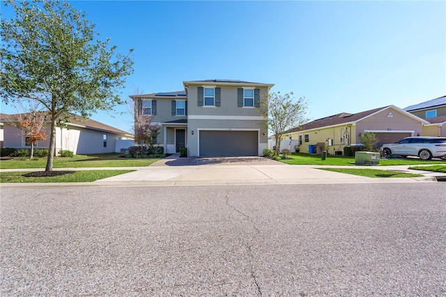 view of front of home with a garage and a front lawn