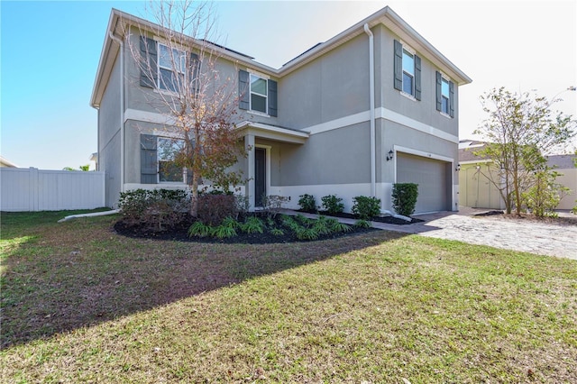 view of property featuring a front yard and a garage