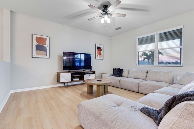 living room featuring ceiling fan and light hardwood / wood-style flooring