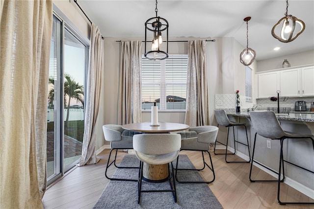 dining area with light hardwood / wood-style floors