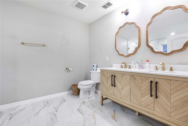 bathroom featuring vanity, toilet, and a textured ceiling