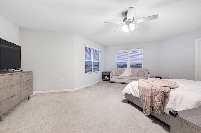 bedroom featuring ceiling fan and light carpet