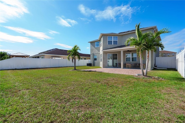 back of house featuring a lawn, a patio area, and central AC unit