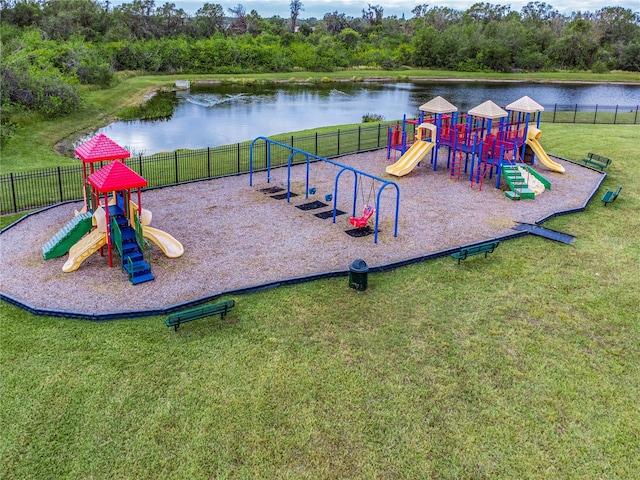 view of jungle gym featuring a lawn and a water view