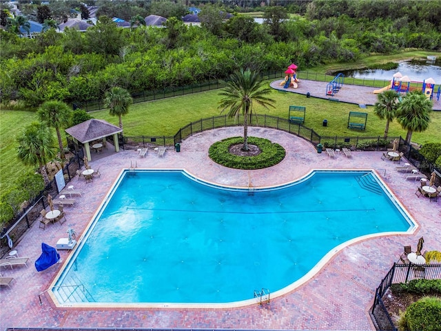 view of swimming pool featuring a gazebo, a water view, and a lawn