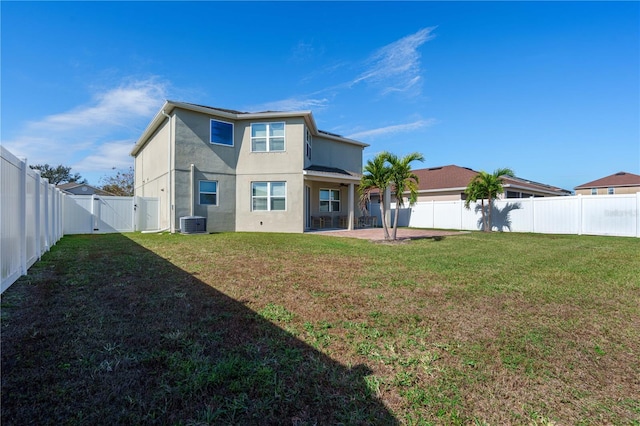 back of house with a yard, a patio area, and central air condition unit