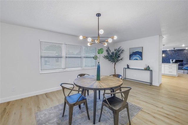 dining area with an inviting chandelier and light hardwood / wood-style floors