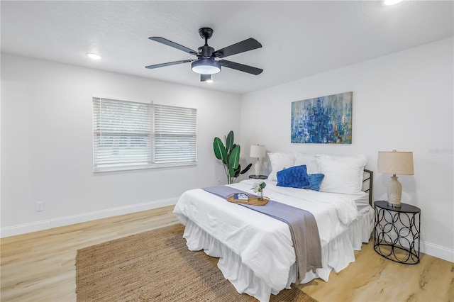 bedroom featuring hardwood / wood-style flooring and ceiling fan