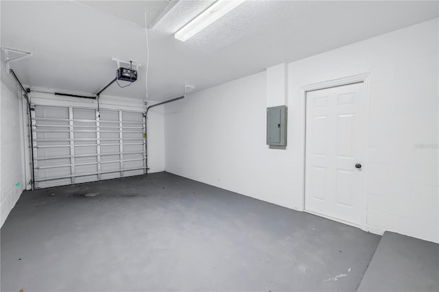 garage with a garage door opener and electric panel