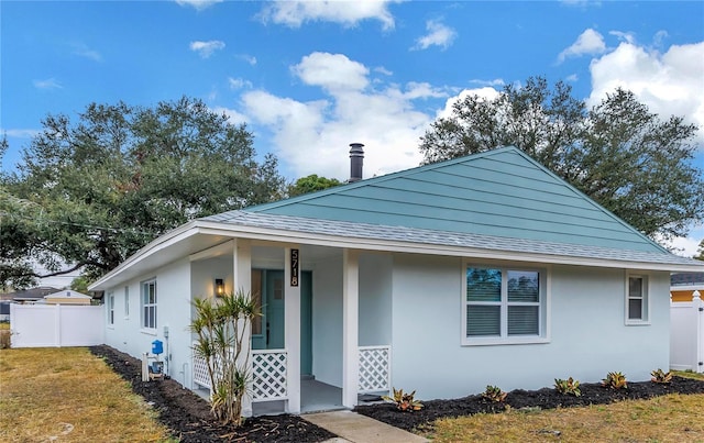 5718 Magnolia St N, Saint Petersburg, FL 33703 - bungalow-style house featuring stucco siding, roof with shingles, and covered porch