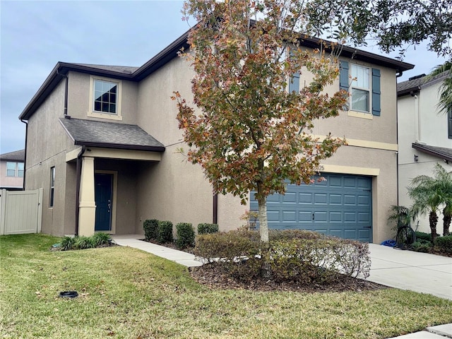 view of front of home with a garage and a front lawn