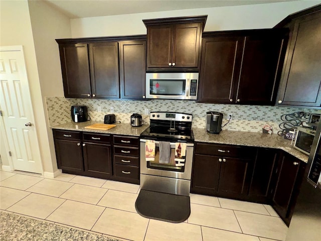 kitchen with dark brown cabinetry, decorative backsplash, and stainless steel appliances