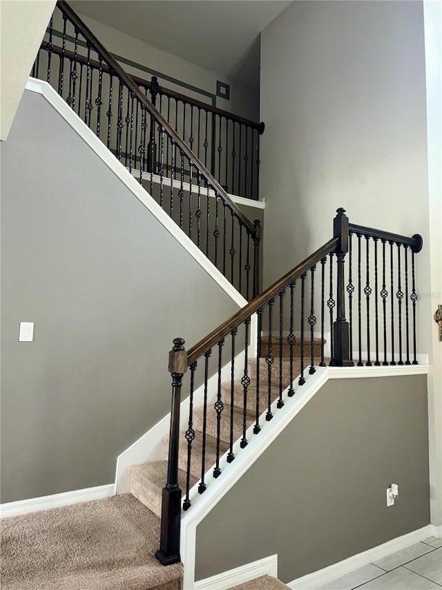 staircase featuring carpet flooring