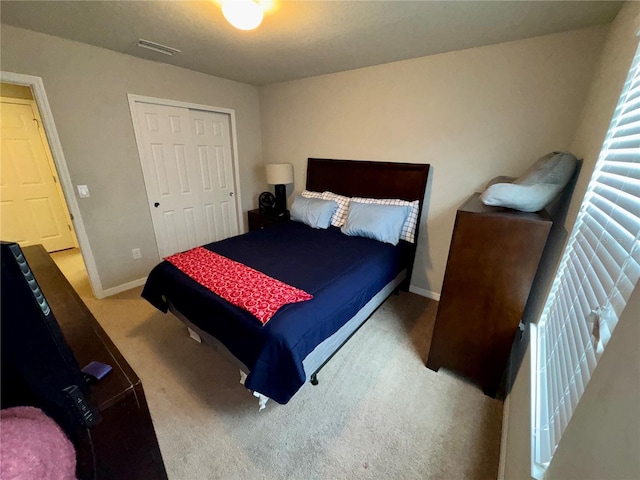 carpeted bedroom with a closet