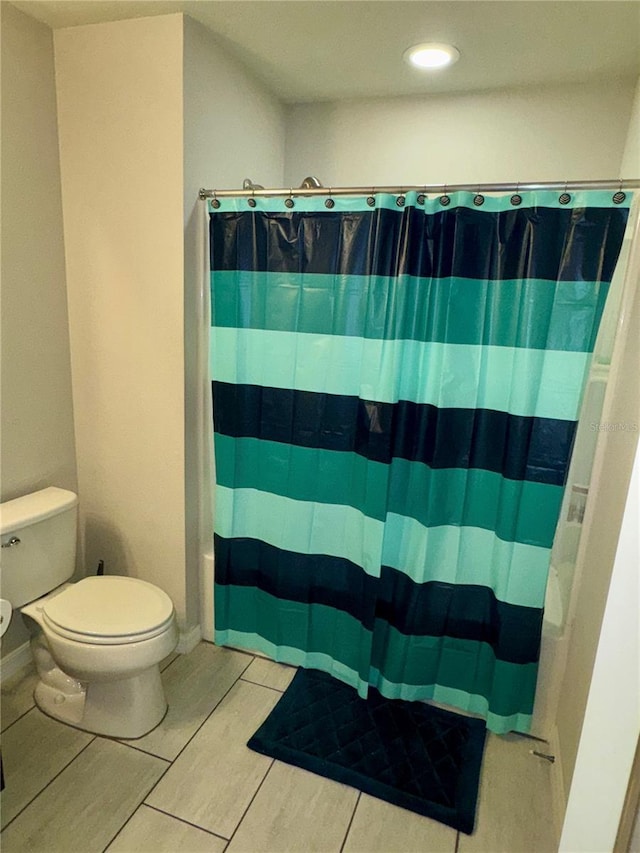 bathroom with tile patterned flooring and toilet