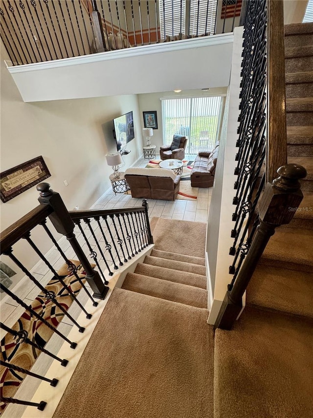 staircase featuring a high ceiling