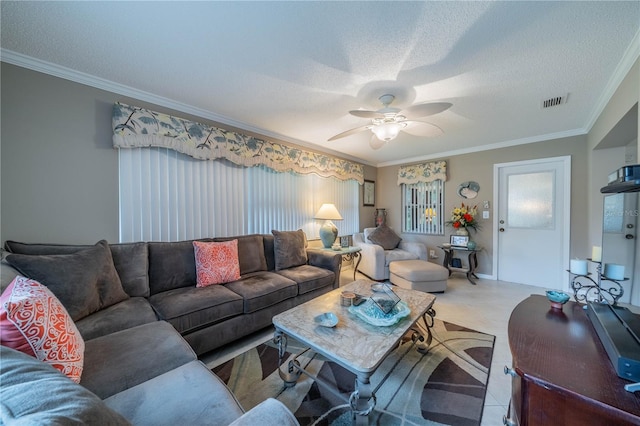 living room with a textured ceiling, ceiling fan, and crown molding