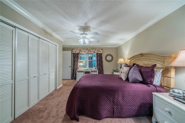 carpeted bedroom with a closet, ceiling fan, and crown molding