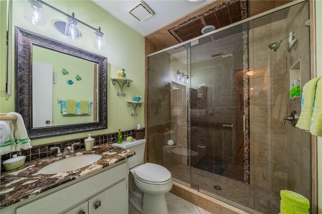 bathroom featuring toilet, an enclosed shower, tile patterned floors, and vanity