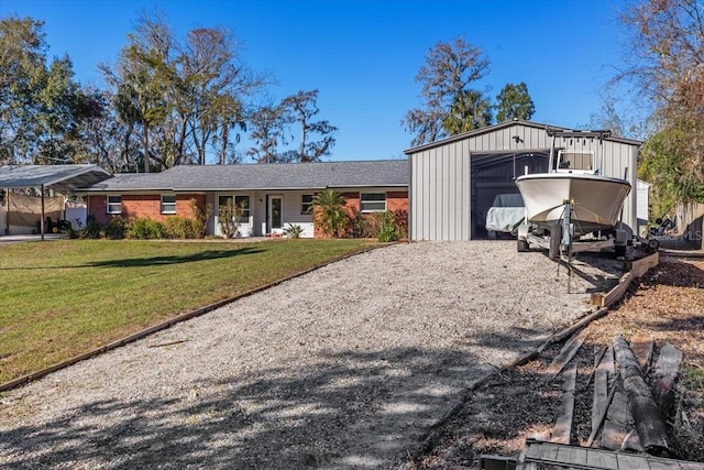 ranch-style house with a front lawn, an outdoor structure, and a garage