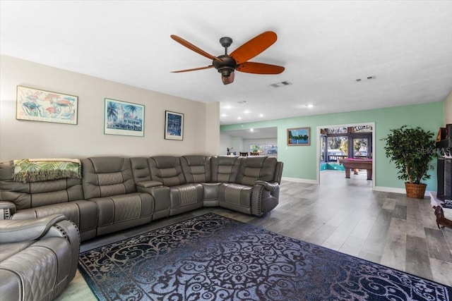 living room featuring hardwood / wood-style flooring, ceiling fan, and pool table