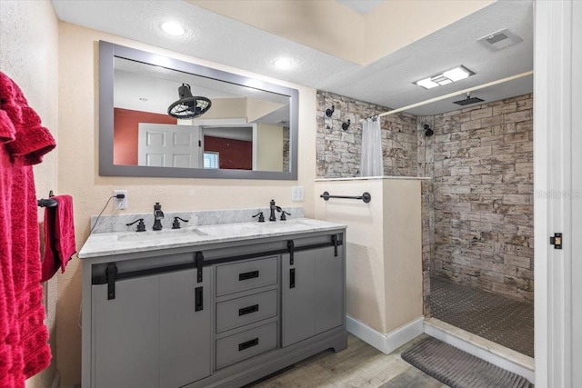 bathroom with vanity, hardwood / wood-style floors, a textured ceiling, and a shower with shower curtain