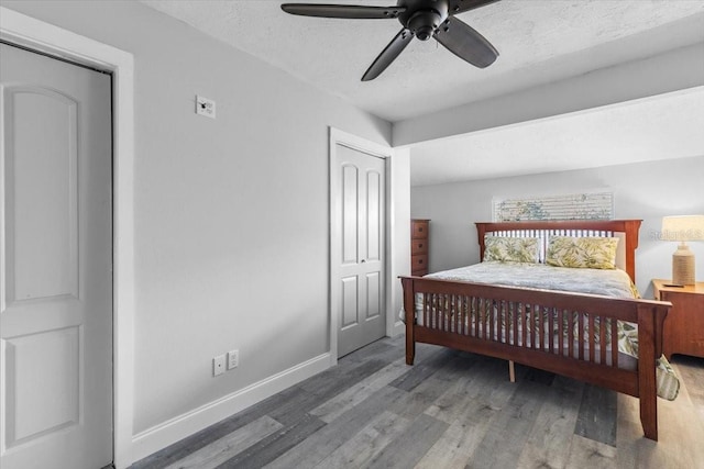 bedroom featuring ceiling fan, wood-type flooring, and a textured ceiling