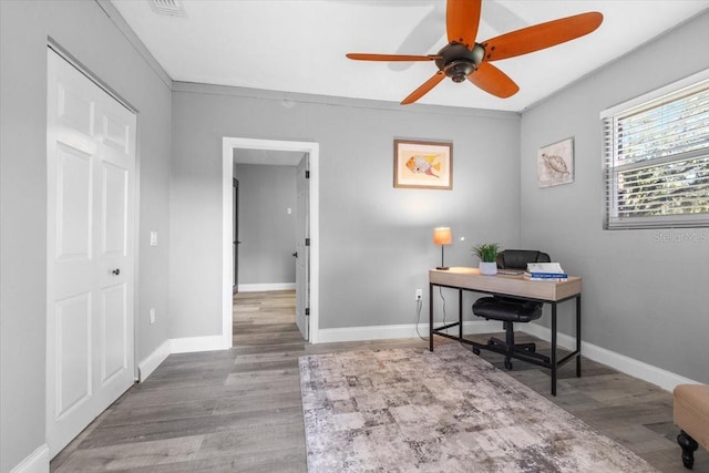 office area with ceiling fan, crown molding, and wood-type flooring