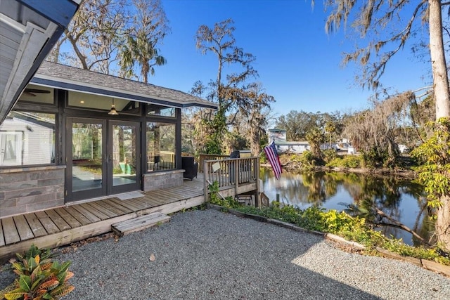 view of yard featuring a water view and a sunroom