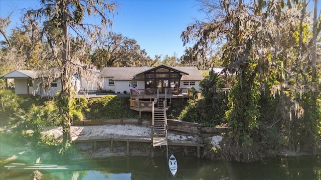 back of property featuring a deck with water view