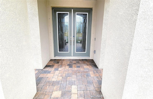 view of exterior entry featuring french doors