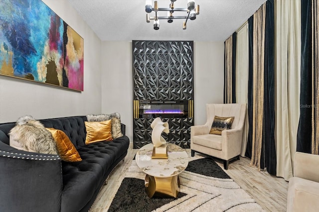 interior space featuring a textured ceiling, light hardwood / wood-style flooring, and an inviting chandelier