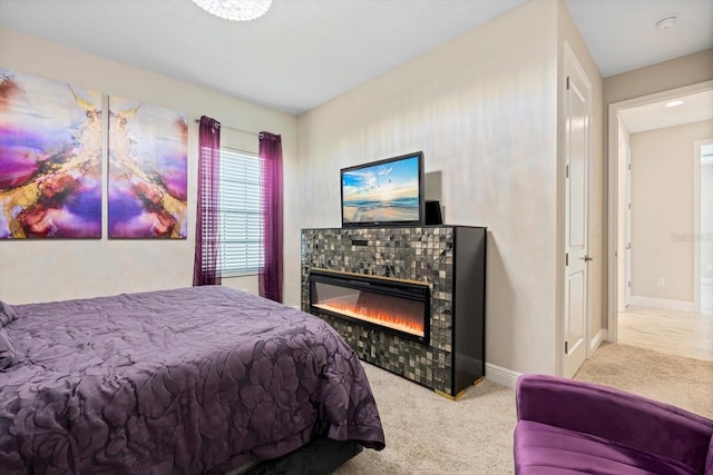 carpeted bedroom with a tile fireplace