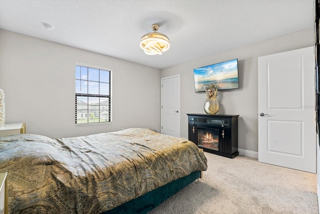 bedroom with light carpet and a textured ceiling