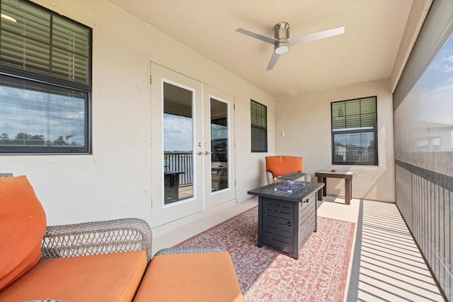 view of patio with french doors, ceiling fan, and an outdoor fire pit