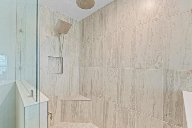 bathroom with a tile shower