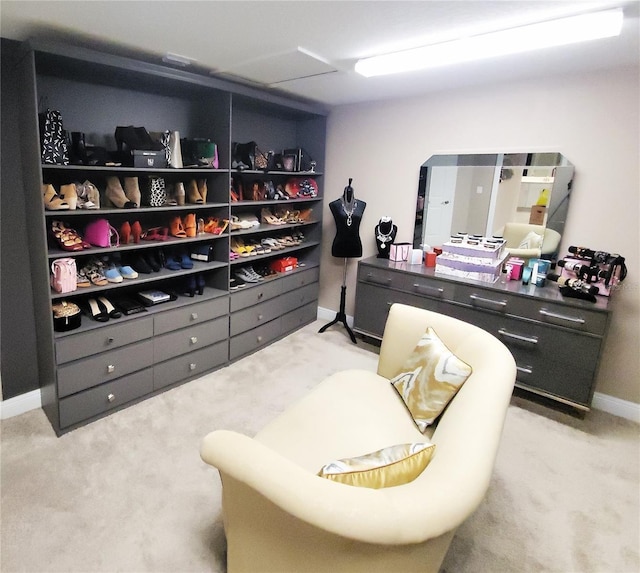 walk in closet featuring light colored carpet